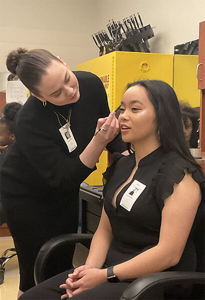 student working on someones makeup